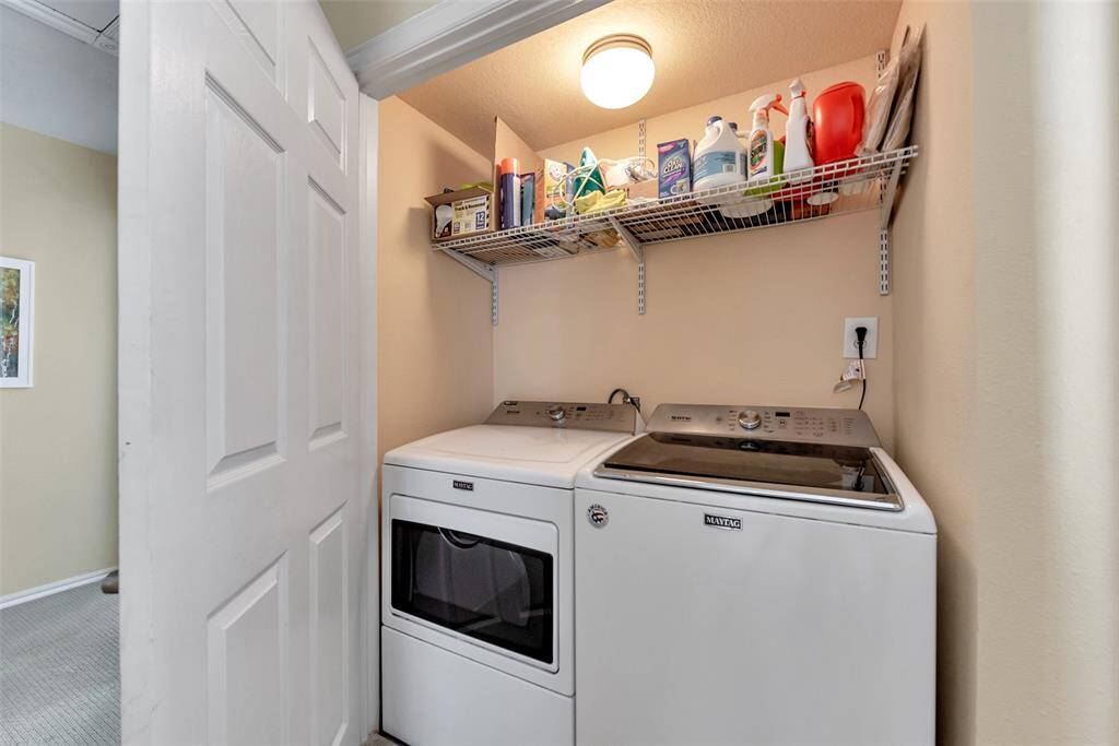 Centrally located on the second floor, this laundry nook offers easy access to all bedrooms with built-in shelving to keep everything organized and within reach.