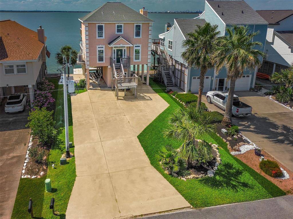 Situated directly on the bay with unobstructed views, this home offers enhanced privacy, a doublewide driveway, and additional parking.
