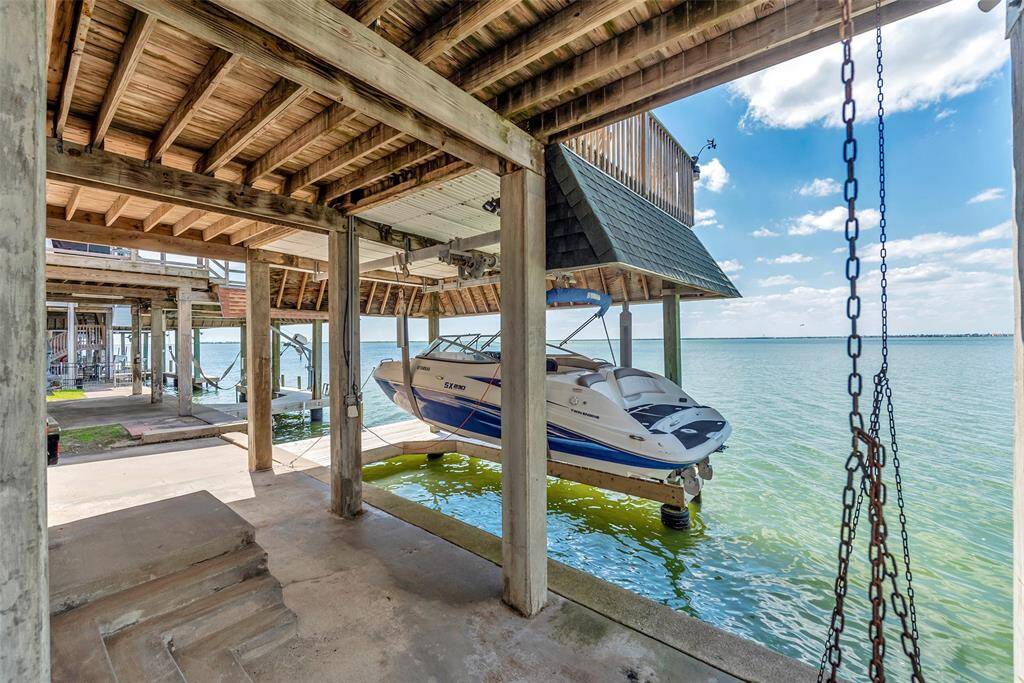 Just steps from the house, this covered boat lift and slip make it easy to hop on the water anytime.