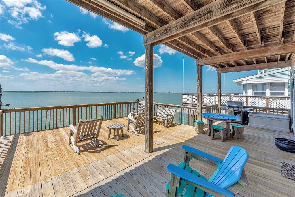 This upper deck offers both covered and open areas, with plenty of space for dining, lounging, and enjoying time around the included outdoor furniture.
