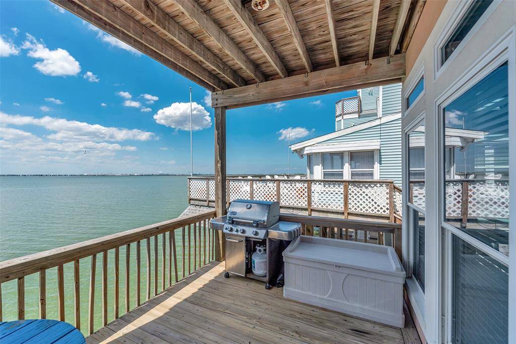 The upper deck has a covered area, with a grill included for outdoor cooking and relaxing.
