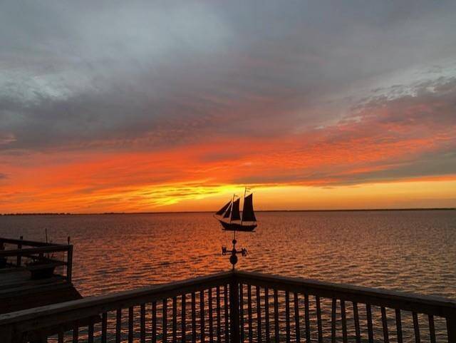 The deck becomes your front-row seat to the day’s last light show. As the sun dips below the horizon, the warm tones light up the water — a peaceful scene that’s all yours to enjoy.