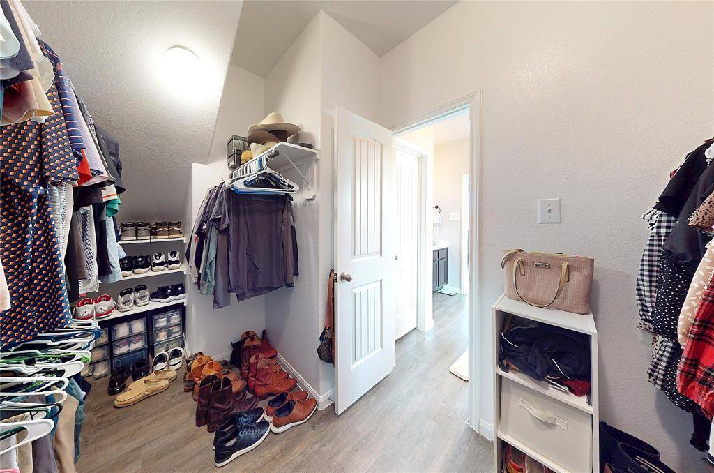 Large, walk-in closet with plenty of rack and shelf space