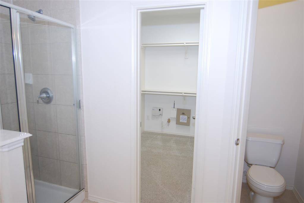 Primary bath, showing separate shower, large closet, and private commode.