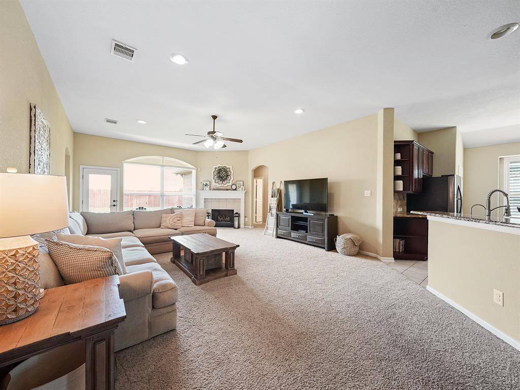 Airy living room with vaulted ceilings and cozy fireplace, perfect for relaxing