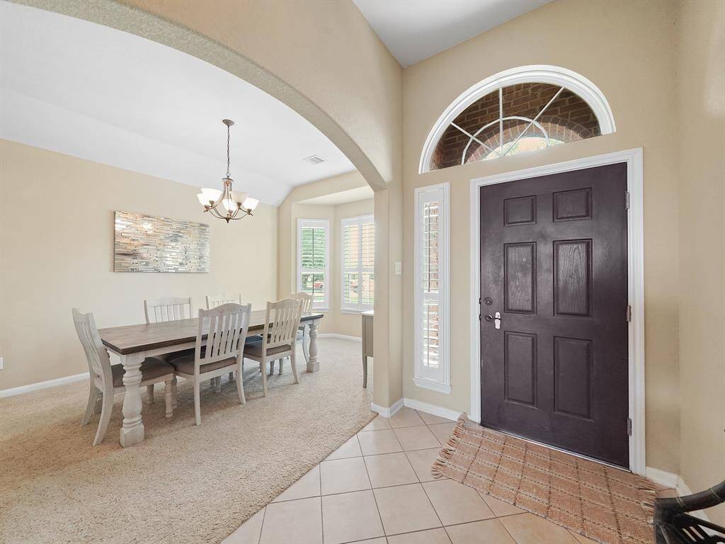 Step into a welcoming foyer with high ceilings and tile flooring that sets the tone for the rest of this stunning home.