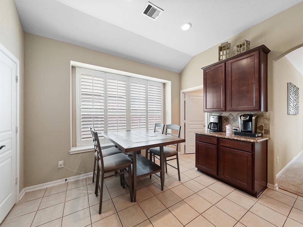 Just off the kitchen, a  breakfast area offers the perfect spot for casual meals, morning coffee (check out that amazing coffee/tea bar), or homework sessions.