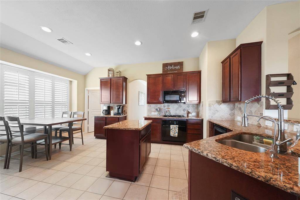 Chef’s kitchen with granite countertops, plenty of storage space and an island.