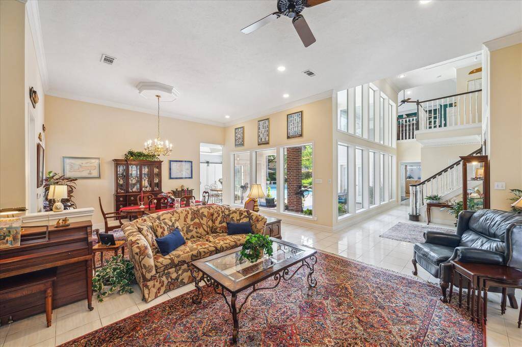 This view from a front corner of the family room overlooking the entry, dining room and the windows overlooking the backyard.