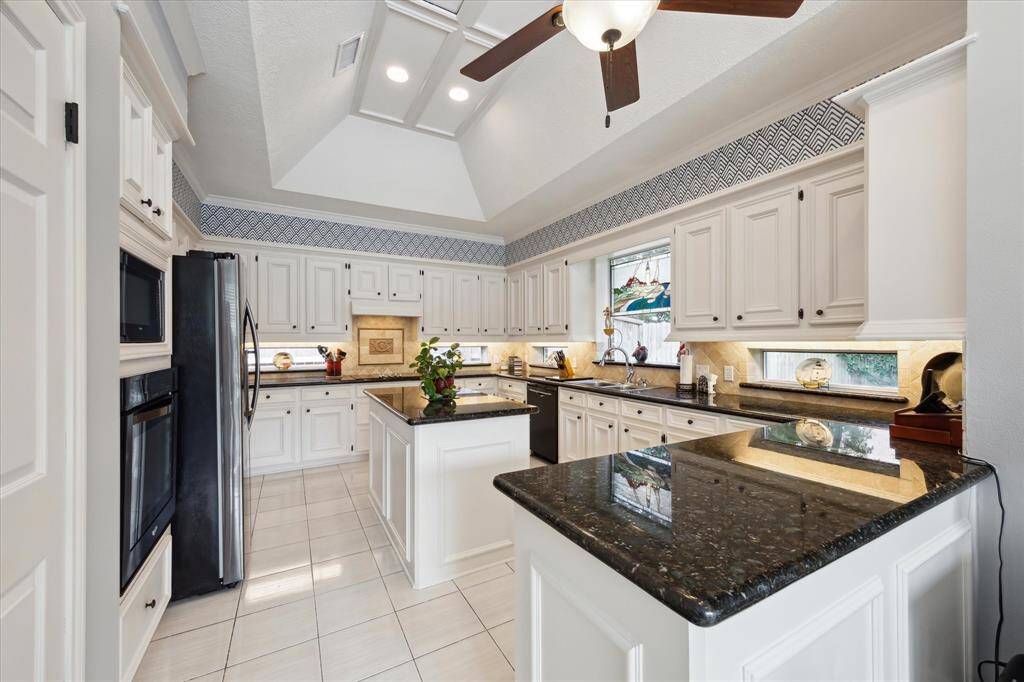 This home has a large kitchen. Slab granite countertops, ceramic tile floor and vaulted ceiling are some of the features.