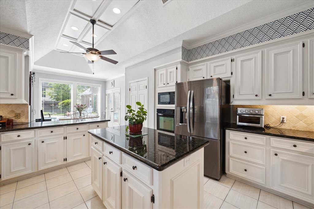 This view across the kitchen looks over the breakfast/serving bar into the breakfast area.