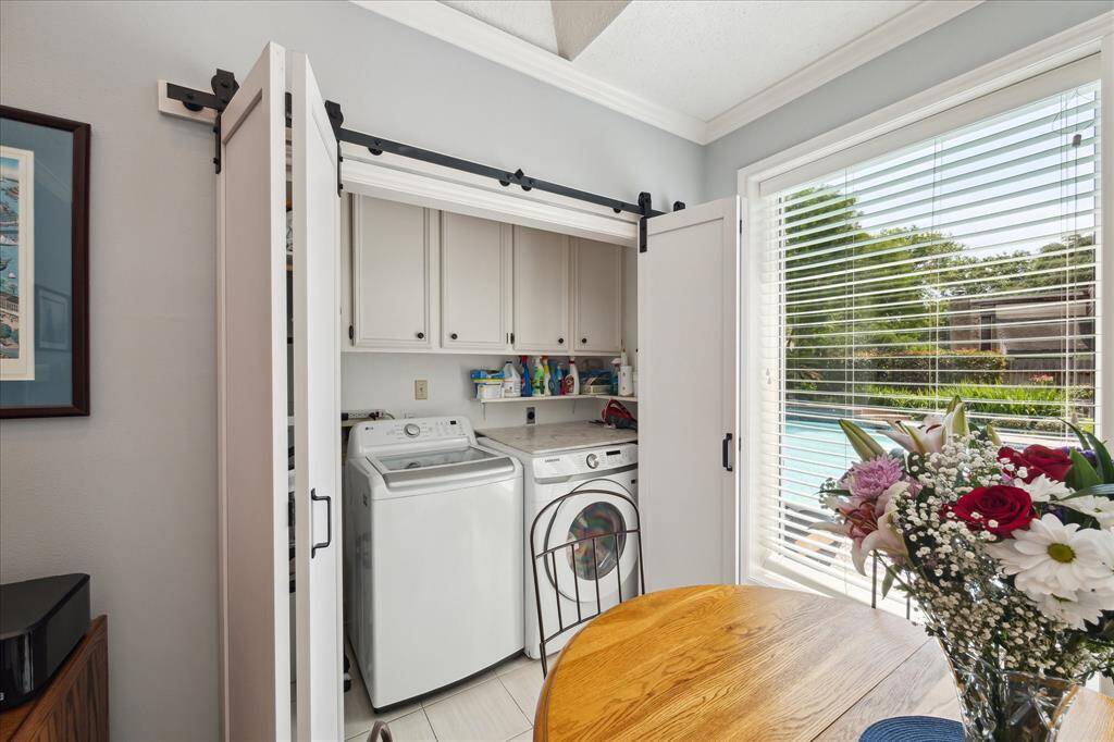 The laundry closet is at the rear of the breakfast room and has built-in cabinet storage.