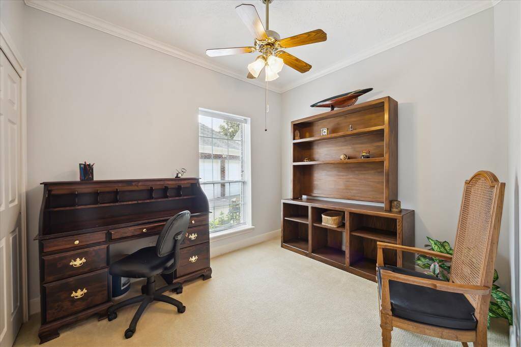 This is the second room in the living quarters portion of the home. This room has carpeted floor, high ceiling accented with crown molding and reach-in closet.