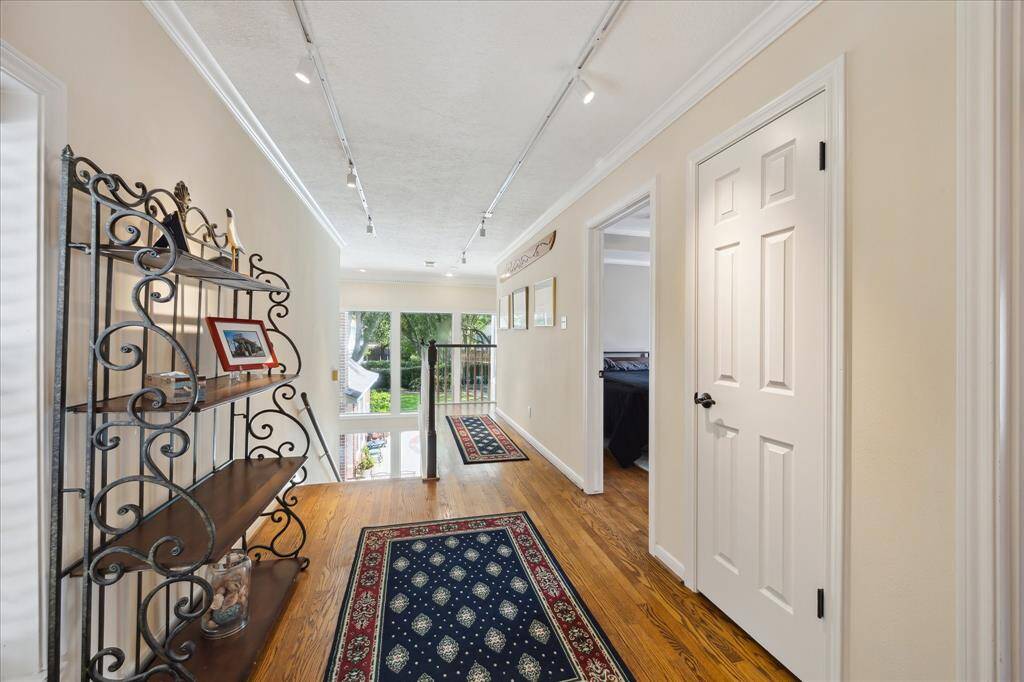 This is a view of the top of the stairs. The upper level has hardwood floors in the gameroom and bedrooms 3 & 4.