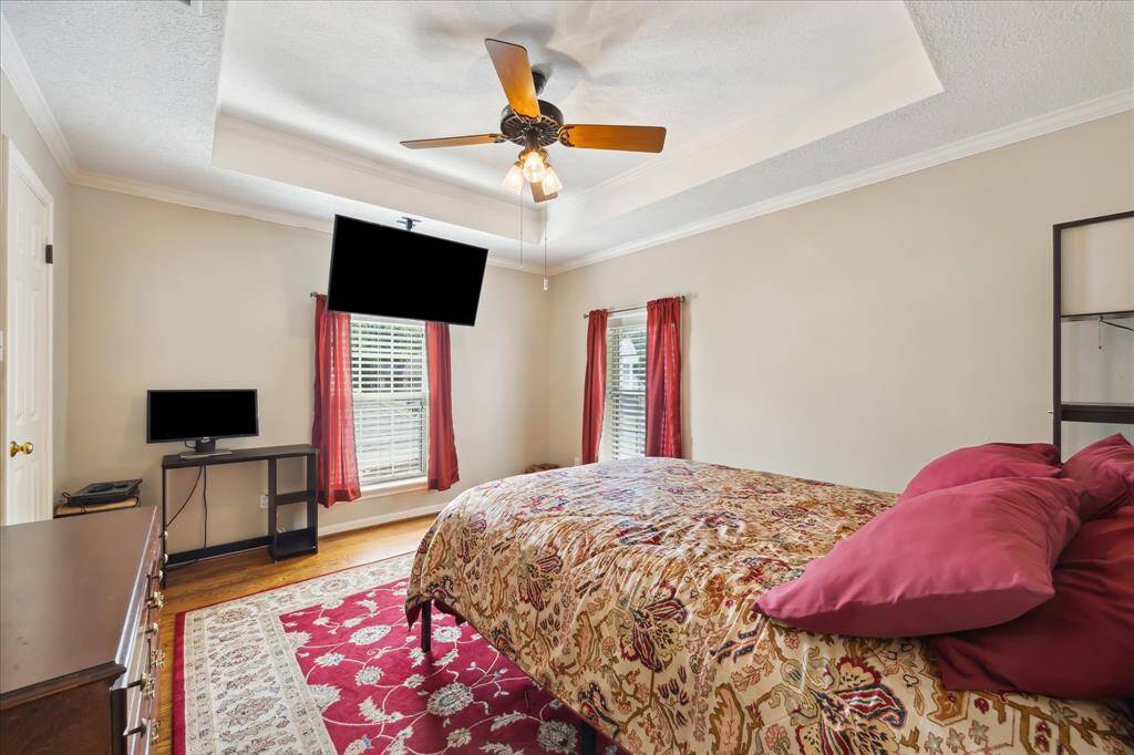 Upper level bedroom 3 also has a coffered ceiling and hardwood floor.