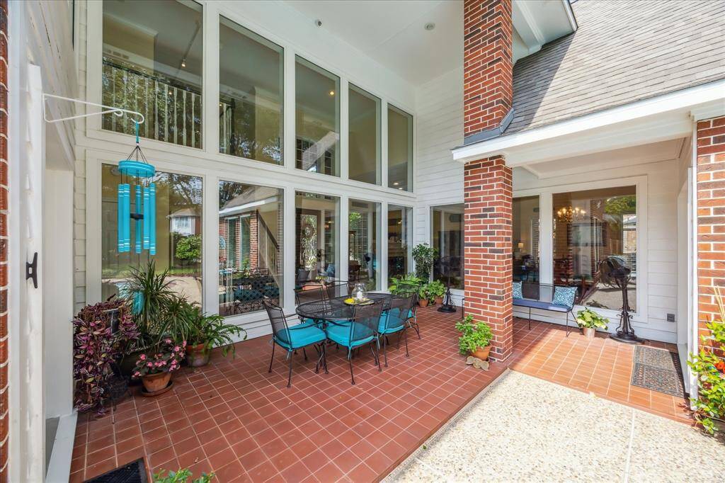 Walls of windows provide great views of the patio area, backyard and pool.