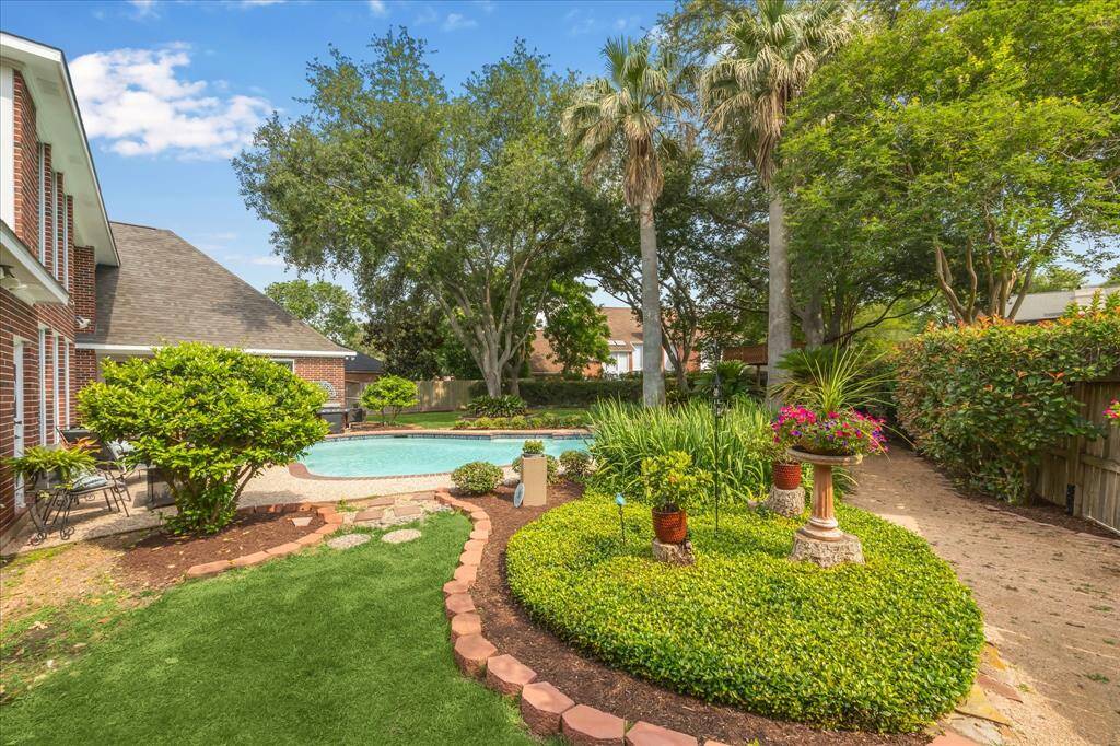 The cul-de-sac lot provides a large backyard that is extensively landscaped.