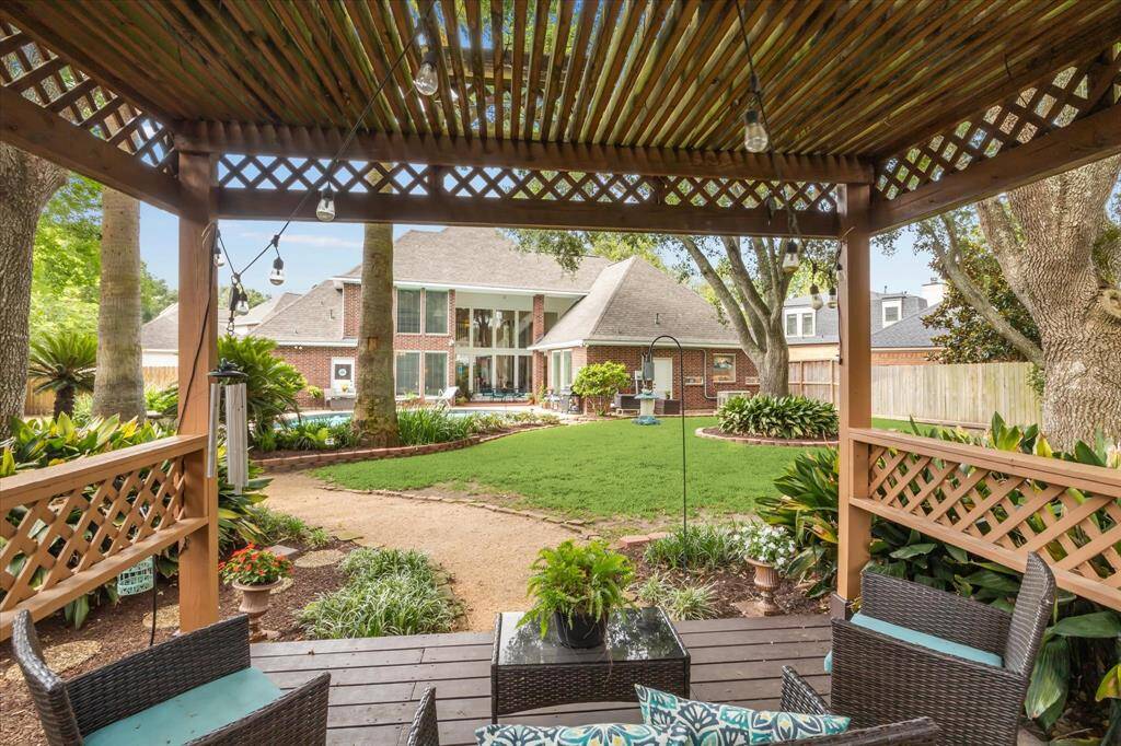 A view from the seating area over the backyard toward the rear of the home.