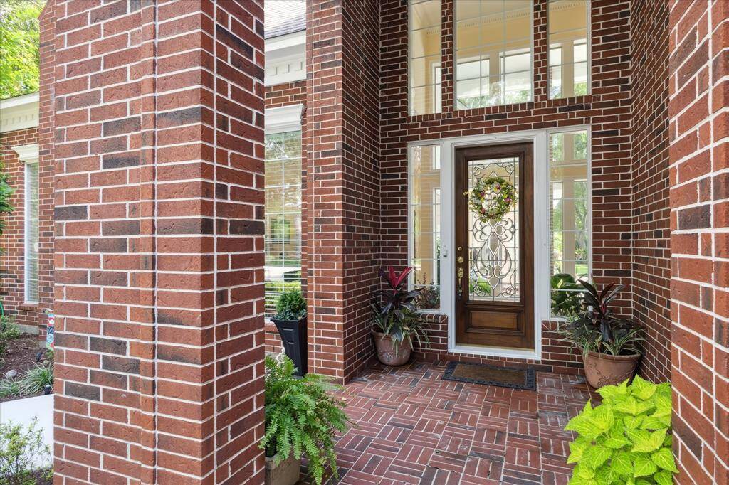 Entry into this beautiful home is through a Mahogany & leaded glass front door that is surrounded by side-lite and overhead windows.
