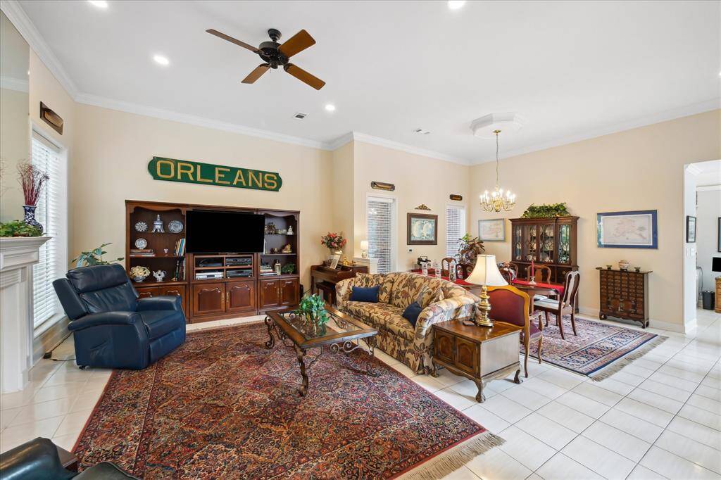 The family room is at the left of the entry. Features include ceramic tile floor, high ceiling, recessed lighting and crown molding.