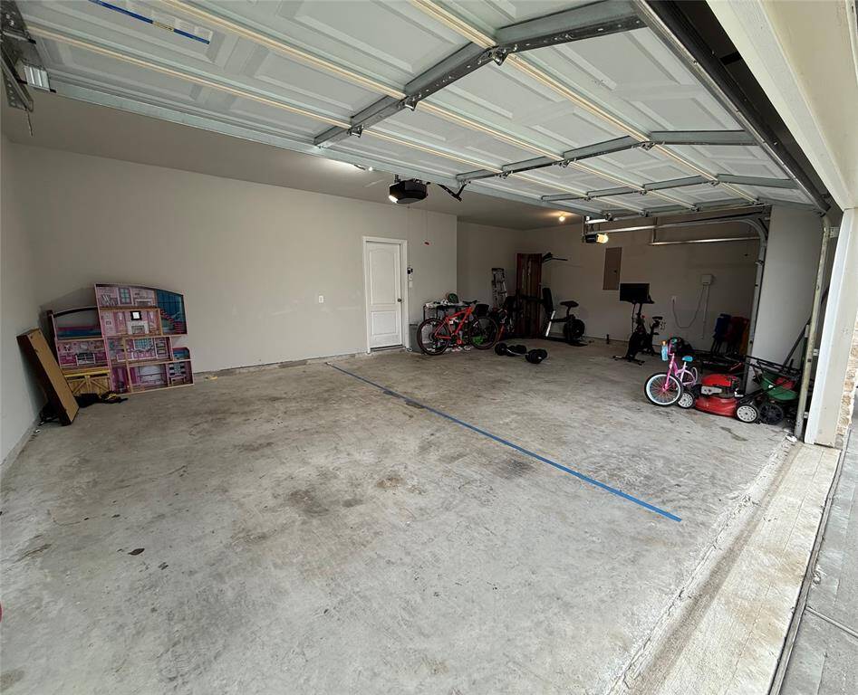Expansive three-car garage offering ample space for vehicles and storage.