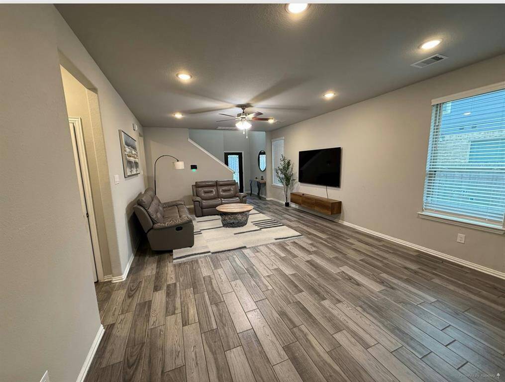 Spacious open floor plan seamlessly connects the kitchen and family area, perfect for modern living.