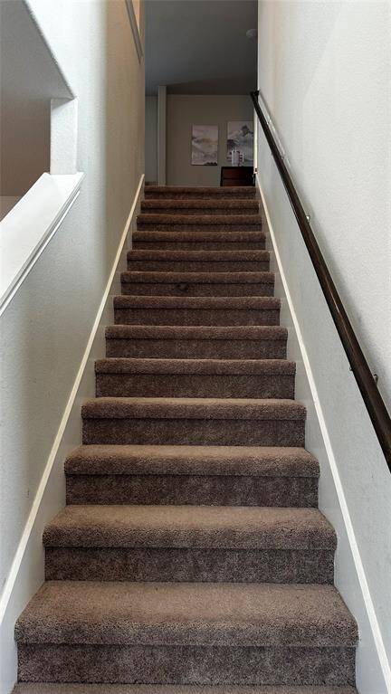 Elegant staircase leading to the second floor.