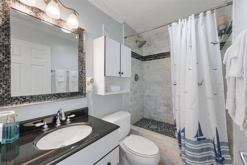 Primary bathroom features a newly upgraded walk in shower
