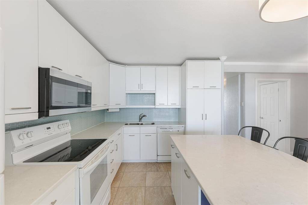 Spacious kitchen allows for entertaining guests with a view of the beach!