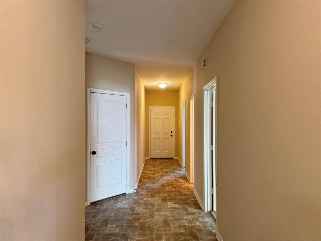Hallway to front door, garage and 3 bedrooms