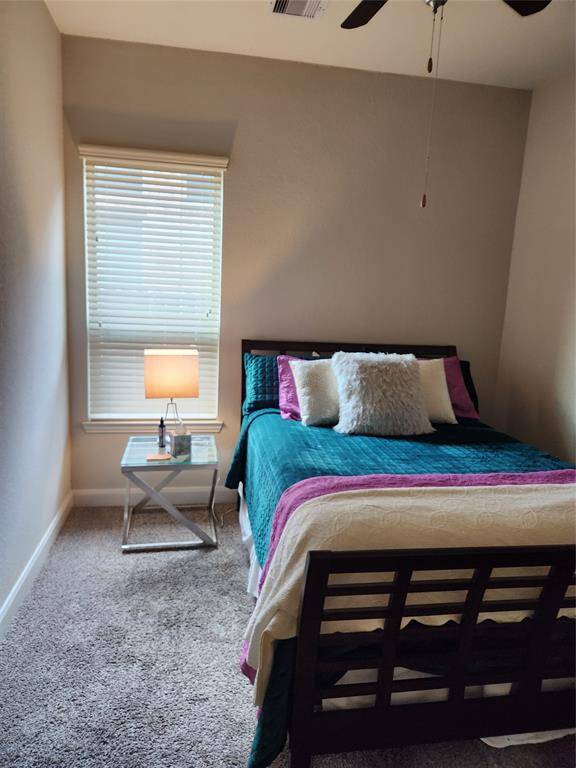 Secondary bedroom fits a queen bed with room to spare.