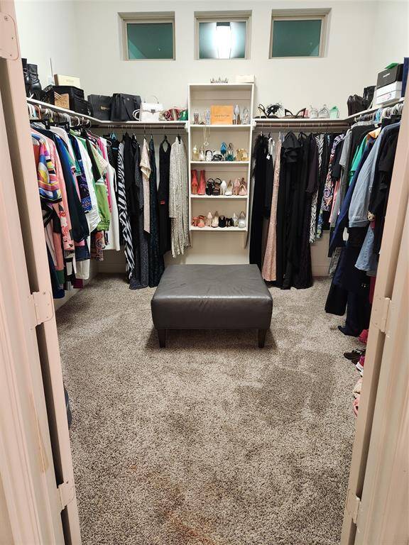 Expansive 10x11 master closet with built-ins natural light, and dressing area