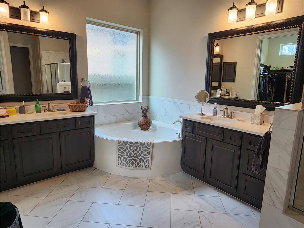 The en suite master bath boasts a luxurious soaking tub and over-sized dual vanities.