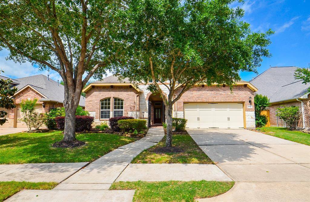 Mother Nature's finest greenery invites us into this welcoming brick beauty at 4926 Erin Ashley Lane, Katy, TX, in the Cinco Ranch Southwest community.