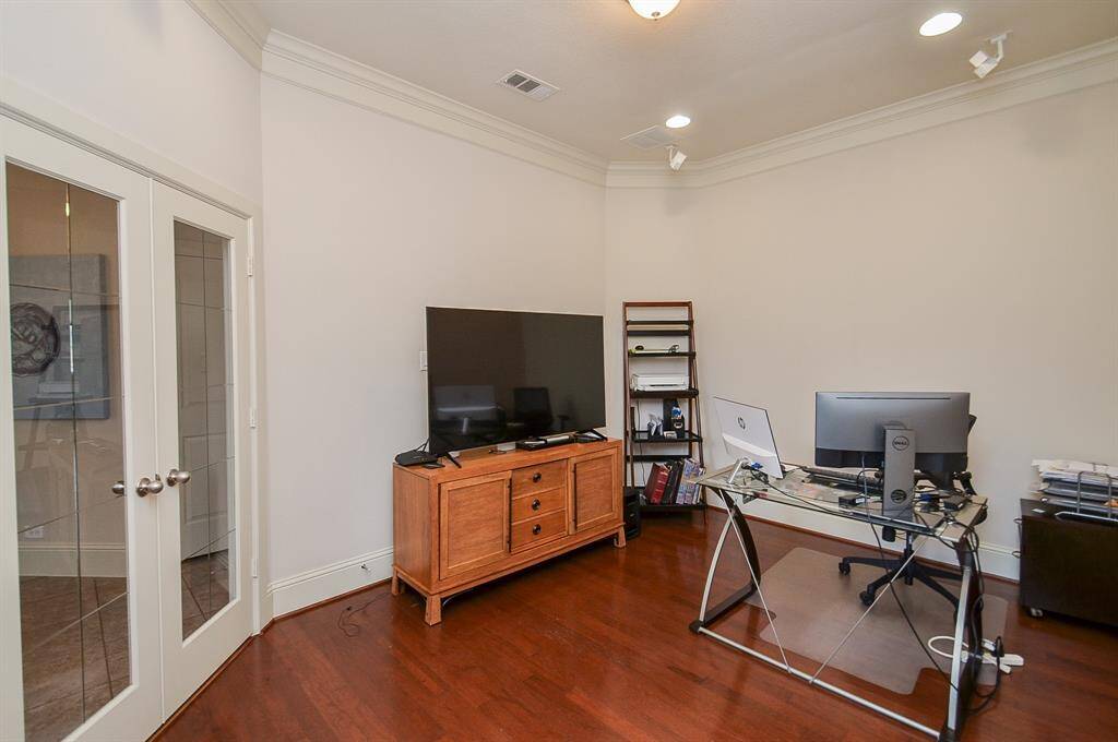 Behind gleaming, glass paneled french doors is this gorgeous home office/ work space.