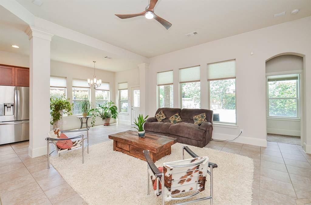 Large windows line walls in this amazing combined living/kitchen space.