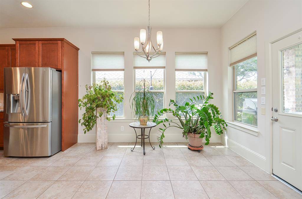 This stunning breakfast/casual dining nook easily accepts sizeable pieces and accents, even green ones, with the handy patio door, right.
