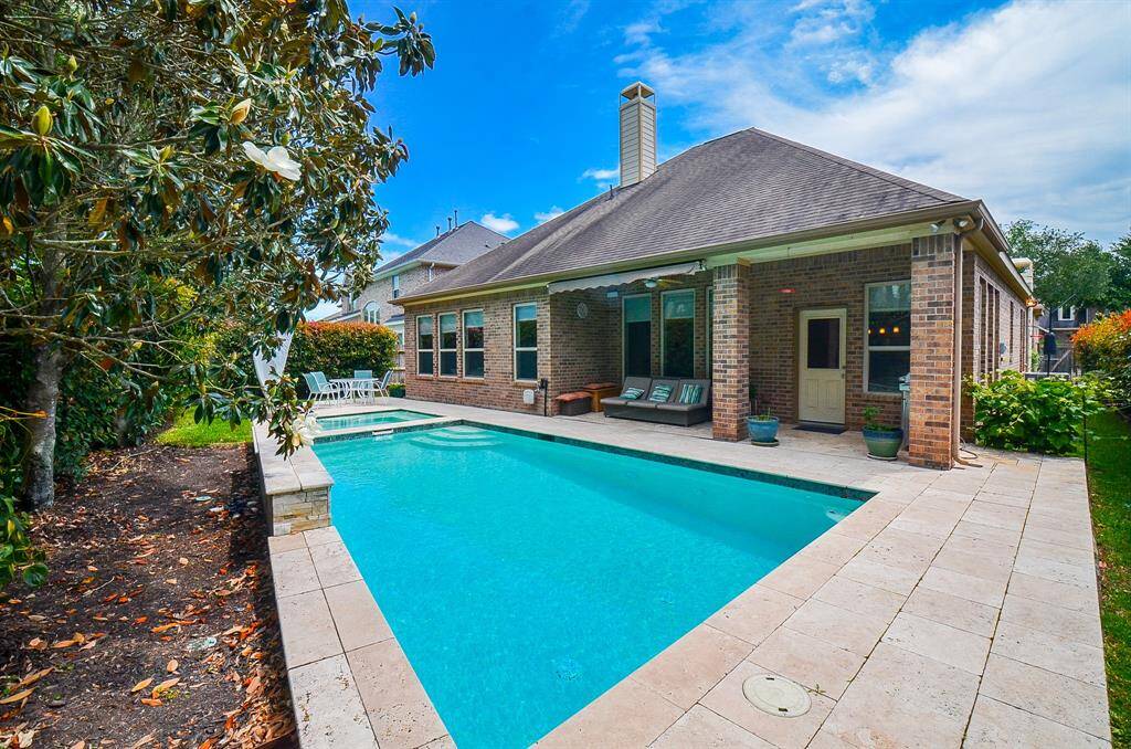 This incredible pool and spa are so tempting in your backyard, surrounded by more mature, natural greenery.