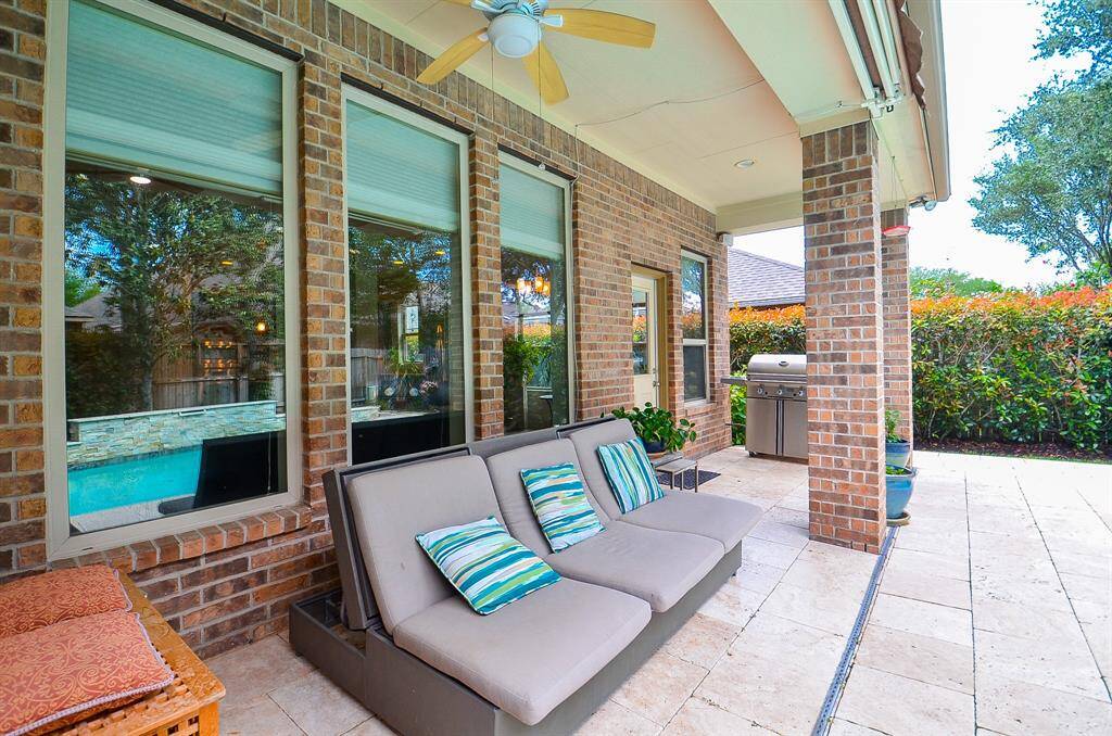 This covered patio provides outdoor relaxation at its best, with plenty of room for seasonal pieces, and the all-important grill waiting to serve, up left.