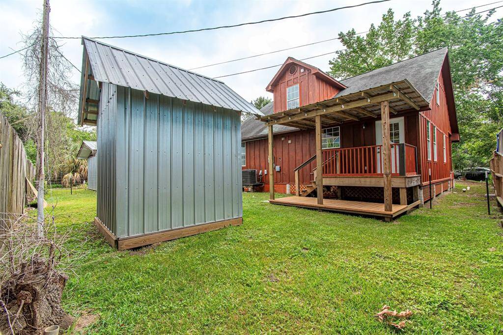 fenced back yard with storage