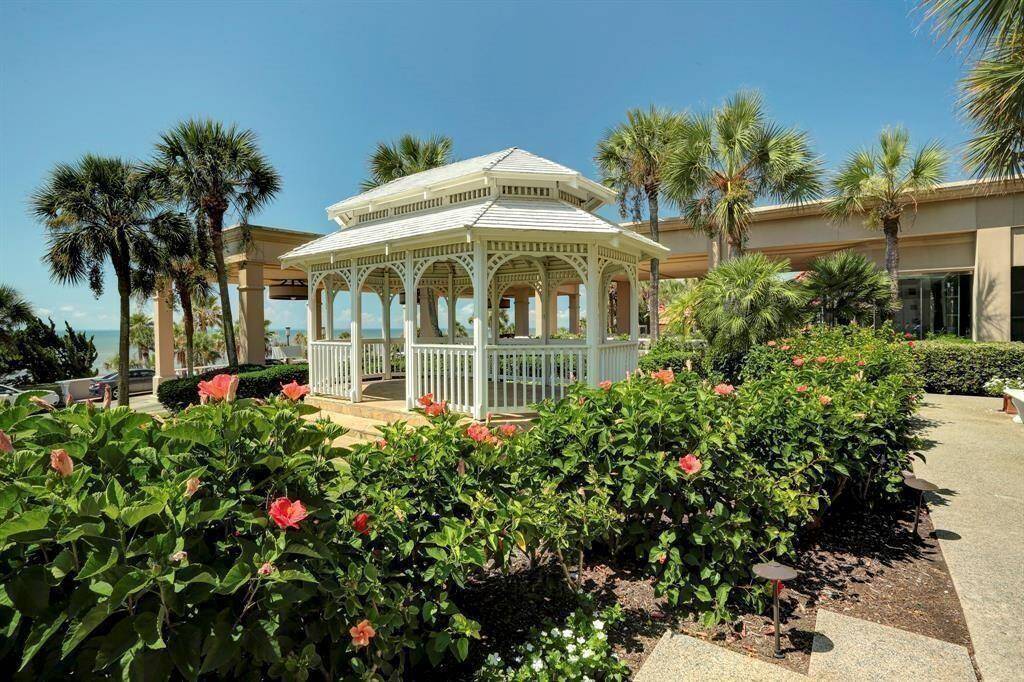 This is an elegant property featuring a charming gazebo amidst lush landscaping with vibrant flowers and palm trees, offering a picturesque ocean view, ideal for outdoor relaxation and entertainment. Enjoy a scheduled massage in the Gazebo by the San Luis Spa