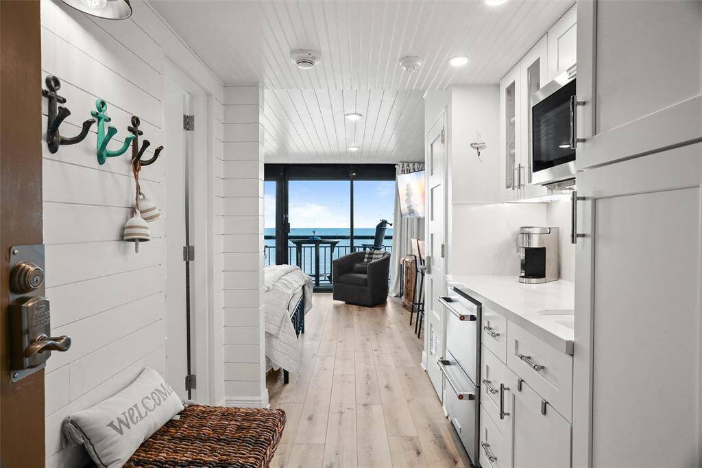 Seeking an elegant waterfront lifestyle? Here it is! This modern, coastal-style studio conveys turn-key with sweeping 12th floor beachfront views. Plus, all the fine features and amenities that the San Luis Resort has to offer. The unit is located just off the elevator in the enclosed cooridor. The entryway leading to an open-plan living space with natural light and oceanfront views, featuring crisp white interiors and hardwood floors. NOTE: New coffee maker & two burner cooktop installed but not pictured