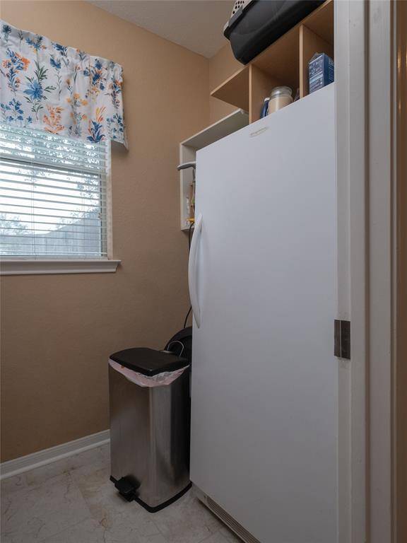 The utility room includes shelving for storage is right off the kitchen. There are washer and dryer hook ups to add a second laundry room if desired.