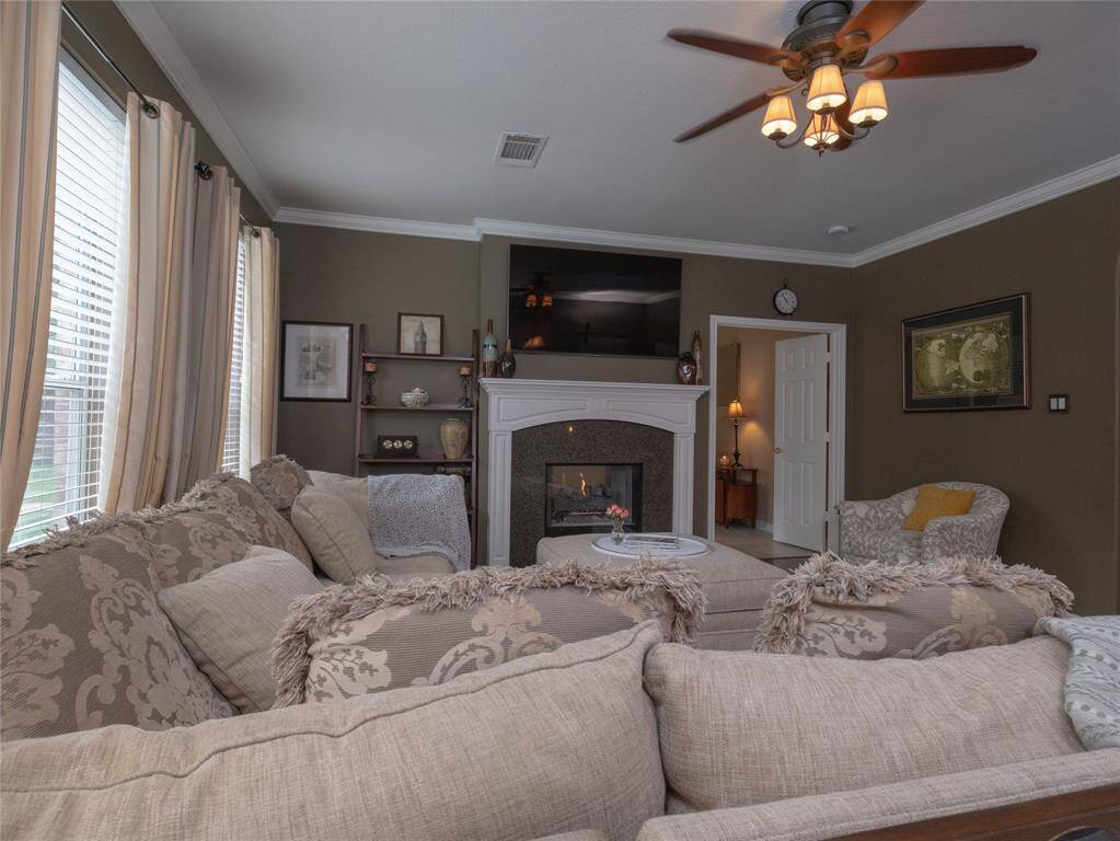 Enjoy this cozy family room with beautiful neutral tones and a well appointed double sided fireplace. This room is bright and cozy.