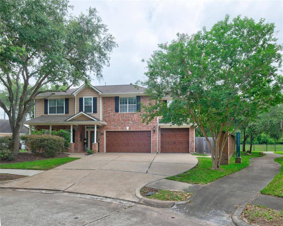 This charming two-story home features a brick facade with a welcoming front porch and a spacious three-car garage. It is surrounded by lush greenery and mature trees, situated on a cul-de-sac lot with a well-maintained lawn. The Riverpark Trail offers many walking trails to enjoy!