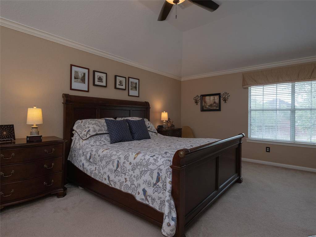 Welcome to your owners retreat! Enjoy the relaxing and quietness of this primary bedroom that features a high ceiling, a large window for natural light, and a cozy atmosphere.