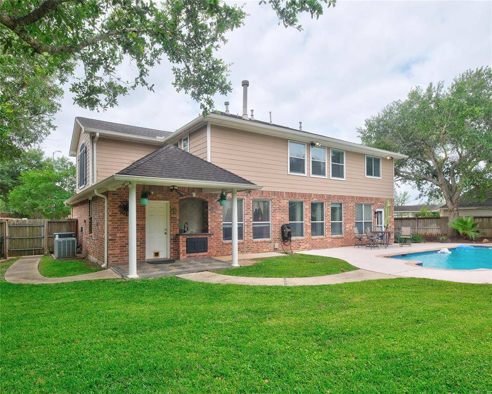 WOW! You will enjoy this spacious backyard with a pool and spa, patio area, and mature trees. Ideal for outdoor entertaining and relaxation.