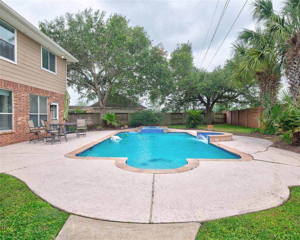 Another view of this large backyard with beautiful landscaping.