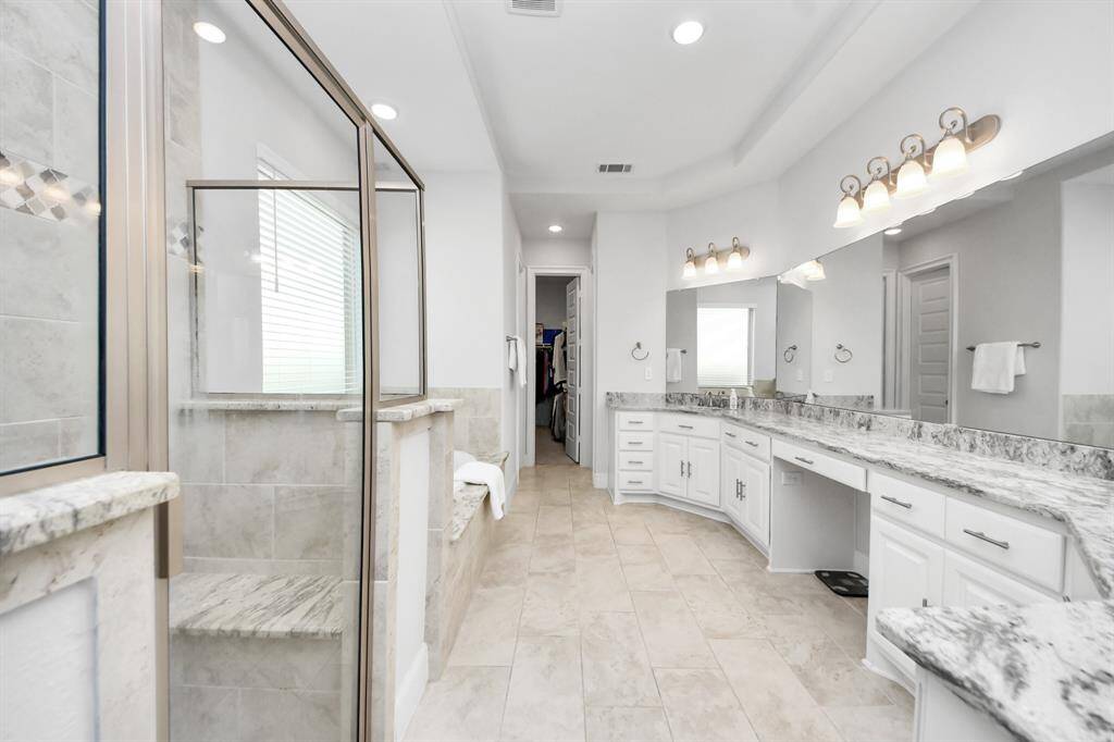 Primary / master bathroom - standing shower and spa tub