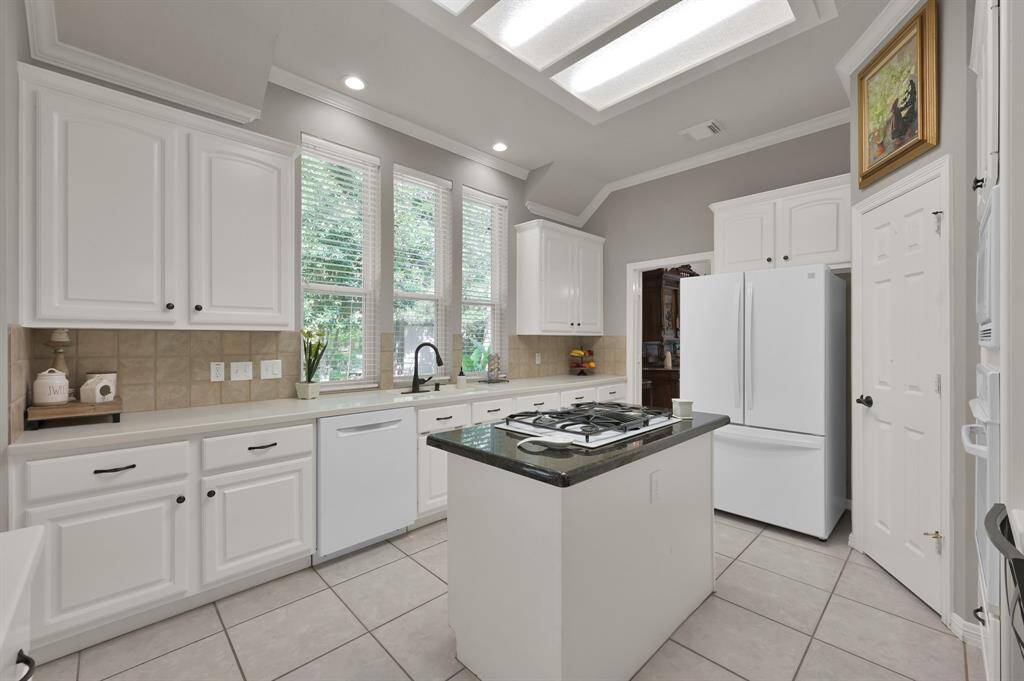 The windows overlooking the kitchen sink let's youbwatch your garden making washing dishes fun